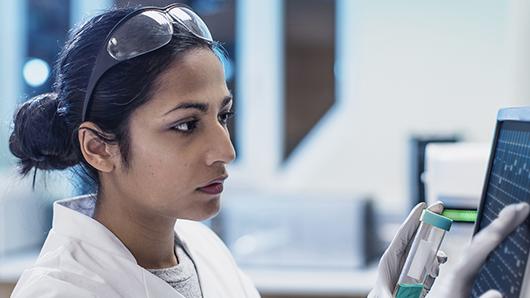 Women at computer assessing research