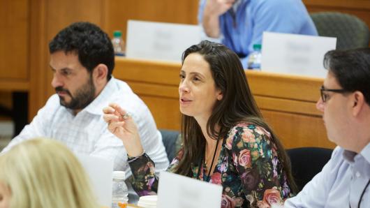 Female and two male executives in a classroom