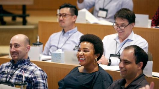 Diverse executives in a HBS executive education classroom