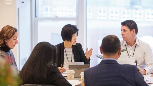 Two male and three female executives in a study session.